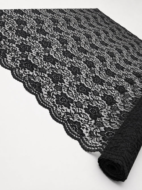 Black Indonesian non-stretch floral lace shown across the roll to display the pattern and scalloped border
